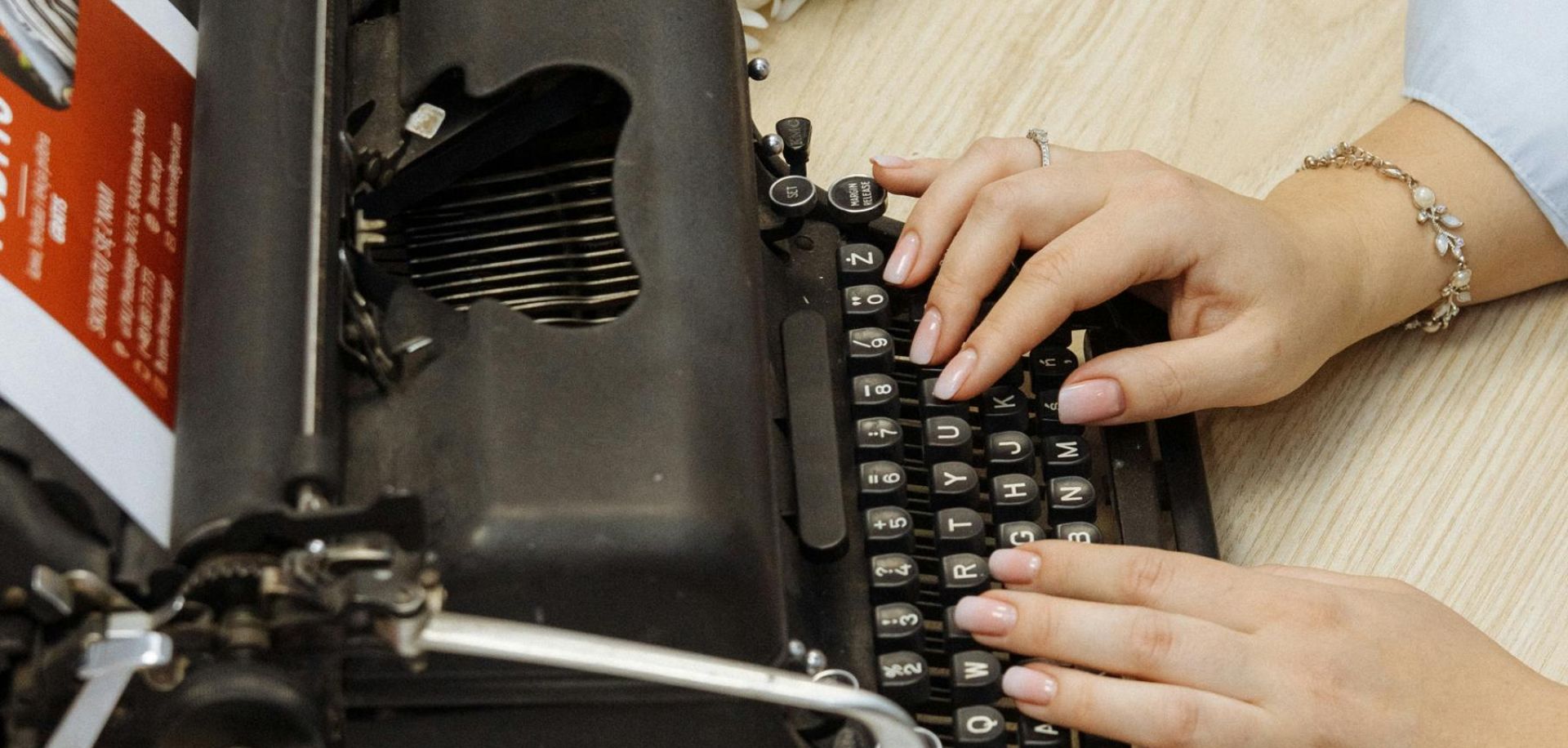 Woman Typing on a Typewriter